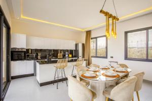 a kitchen and dining room with a table and chairs at Villa Ines with heated pool & panoramic views in El Aïn