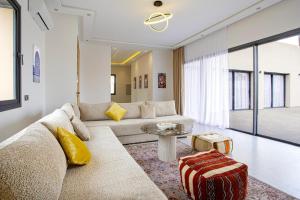 a living room with a couch and a table at Villa Ines with heated pool & panoramic views in El Aïn
