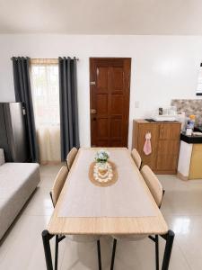 a living room with a wooden table and chairs at Balay in Butuan +7 photos