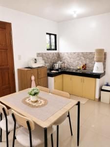 a kitchen with a table and chairs in a room at Balay in Butuan