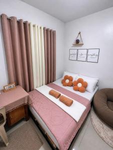 a bedroom with a bed with a teddy bear on it at Balay in Butuan