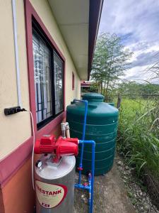 a couple of water tanks sitting next to a building at Balay in Butuan