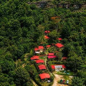a group of houses with red roofs on a hill at Hotel Campestre Rocas Del Paraíso in Machetá