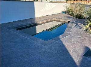 a swimming pool in the middle of a patio at La Perpignanaise in Perpignan