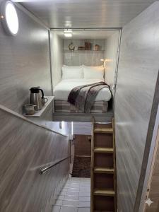 a small bedroom with a bed in a trailer at Chip Central Host in Chişinău