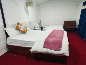a bedroom with a bed with a blanket on it at Newari chulo ghar in Bhaktapur