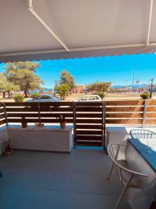 a balcony with a view of a parking lot at Corfu port apartment in Mantoúkion