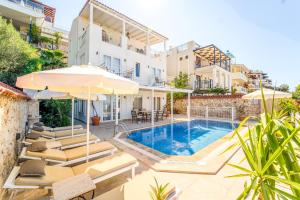a villa with a swimming pool and patio furniture at VILLA LEDA MARE KALKAN Sea View, Private Pool & Beach Clubs in Kalkan