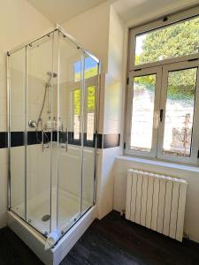 a shower stall in a bathroom with two windows at Villa Tergeste in Trieste +138 photos