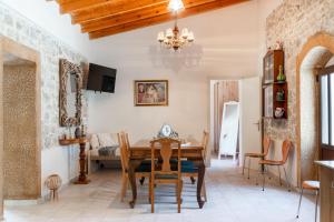 a dining room with a wooden table and chairs at Stone Cottage in Morónion