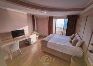 a bedroom with a bed and a desk with a television at Mirage Hotel & SPA - Struga in Struga