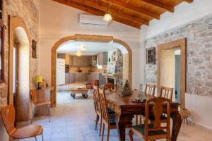 a kitchen and dining room with a table and chairs at Stone Cottage in Morónion