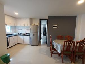 a kitchen with a table and chairs and a refrigerator at Gran Vista in Fusagasuga