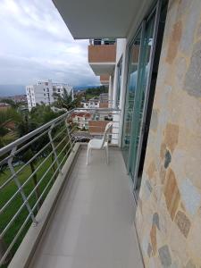 a balcony with a white chair on a building at Gran Vista in Fusagasuga