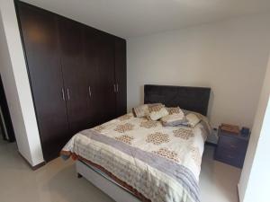 a bedroom with a bed and a large brown cabinet at Gran Vista in Fusagasuga +7 photos