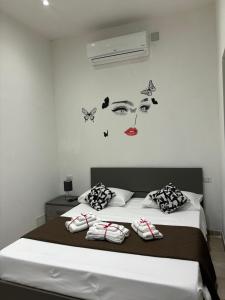 a bedroom with a bed with a face on the wall at Mambo House in Milan