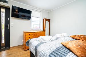a bedroom with two beds and a window at Dwie Sowy by Baltic Home in Międzyzdroje