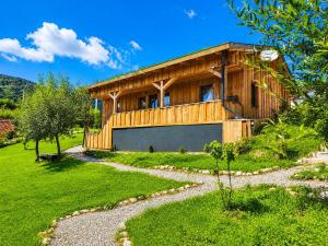 a large wooden house with a gravel driveway at Casa WEZLY 2 in Măgura