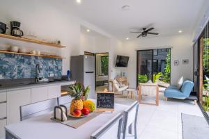 a kitchen and living room with a table with fruit on it at Somnara Espuma de Mar Shared Pool in Punta Uva +8 photos