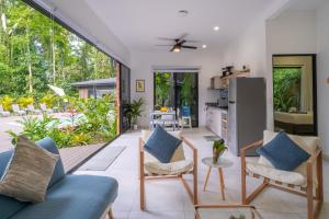 a living room with a blue couch and chairs at Somnara Espuma de Mar Shared Pool in Punta Uva