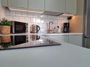 a kitchen with white appliances and a counter top at Lönngården in Kristinestad