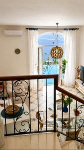 a room with a balcony with a view of the ocean at Casa Intiso - Two double bedroom apartment in Positano