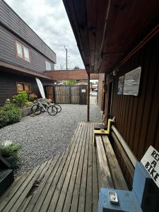 a wooden porch with a bike parked next to a building at Hostal Palguin 261 in Pucón