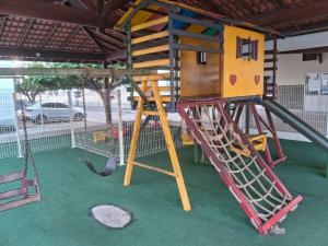 a playground with a tree house and a slide at Praia da Costa próx da Praia in Vila Velha