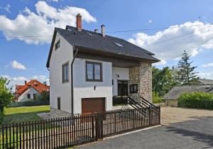 a small white house with a black roof at Blackbird Apartment in Balatonfüred +32 photos