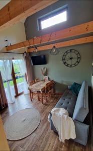a living room with a couch and a table at Domek na Folwarku z jacuzzi in Tarnawa Dolna