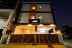 a building with a sign on the front of it at Townhouse Coimbatore International Airport Formerly MK Elegance Inn in Coimbatore +25 photos