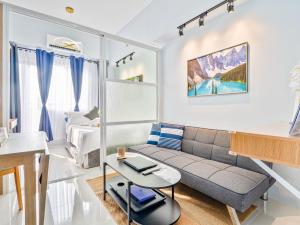 a living room with a couch and a table at Lumiere Prime Studio - Mactan Pool Escape in Pajak