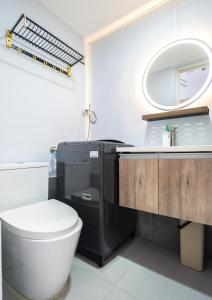a bathroom with a toilet and a sink at Lumiere Prime Studio - Mactan Pool Escape in Pajak +9 photos