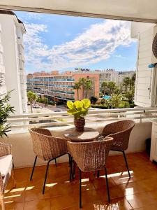 a balcony with a table and chairs and a large window at LA MER BLEUE, Boutique Apartament with free parking, full equipped in Fenals Beach in Lloret de Mar