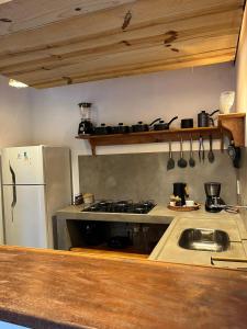 a kitchen with a stove and a refrigerator at Casa bambu atins in Atins +14 photos