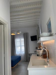 a kitchen with a sink and a bed in a room at Gemelos Cozy Stay in Megali Ammos +72 photos