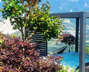 a view from a house with a tree and flowers at Residence Pranterhof in Marlengo