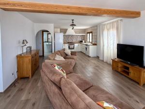a living room with two couches and a tv at Casa Joanna Lanzarote in Nazaret