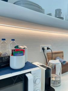 a kitchen counter with a counter top with a microwave at Gemelos Cozy Stay in Megali Ammos