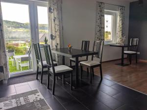 a dining room with a table and chairs and a window at Stop & Sleep - Private Rooms in Ybbs an der Donau