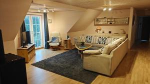 a living room with a couch and a table at Fewo Skjærnsøde in Fjerritslev