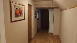 a hallway with a painting of apples on the wall at Fewo Skjærnsøde in Fjerritslev