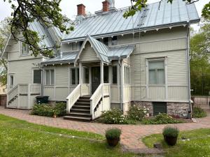 an older house with a metal roof and a porch at Tornvillan in Mariehamn
