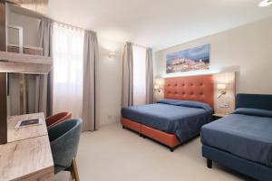 a hotel room with two beds and a couch at Albergo Della Posta in Bracciano
