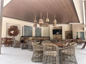 a dining room with a table and wicker chairs at Hotel Boutique Casa Ceibas in Cuautla Morelos