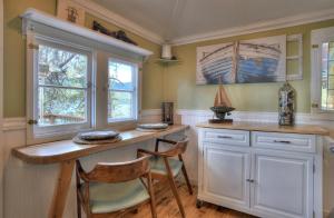 a kitchen with a desk and two chairs at Red Bungalow Vallecito Studio Cabin near Durango, CO in Bayfield