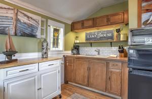 a kitchen with wooden cabinets and white appliances at Red Bungalow Vallecito Studio Cabin near Durango, CO in Bayfield +12 photos