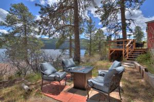 a group of chairs and a table on a patio at Red Bungalow Vallecito Studio Cabin near Durango, CO in Bayfield