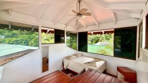 a room with a bed and large windows at Casa Wolaba in Puerto Viejo +35 photos