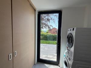 a door to a room with a washing machine at Maison Unifamiliale in Theux